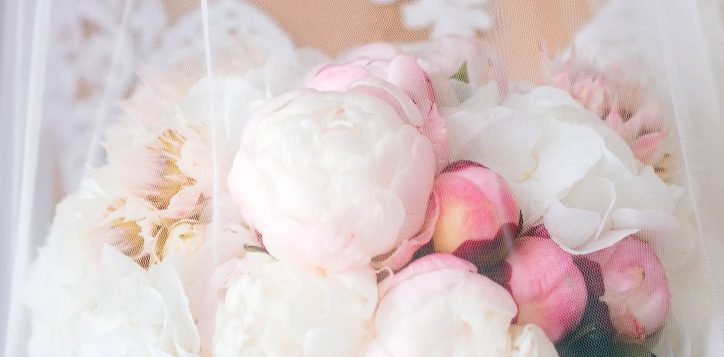 closeup-bride-beautiful-dress-that-holds-wedding-bouquet-is-covered-with-veil-2